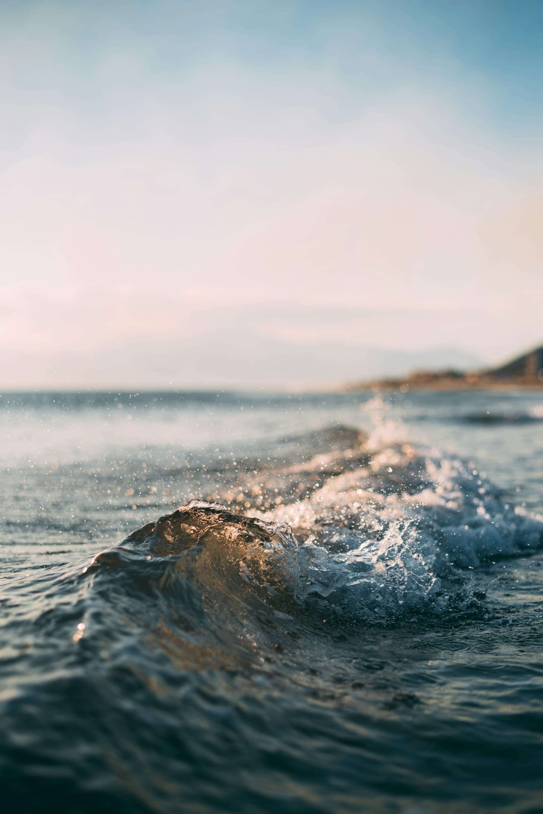 Sunlit waves breaking along a tropical shoreline