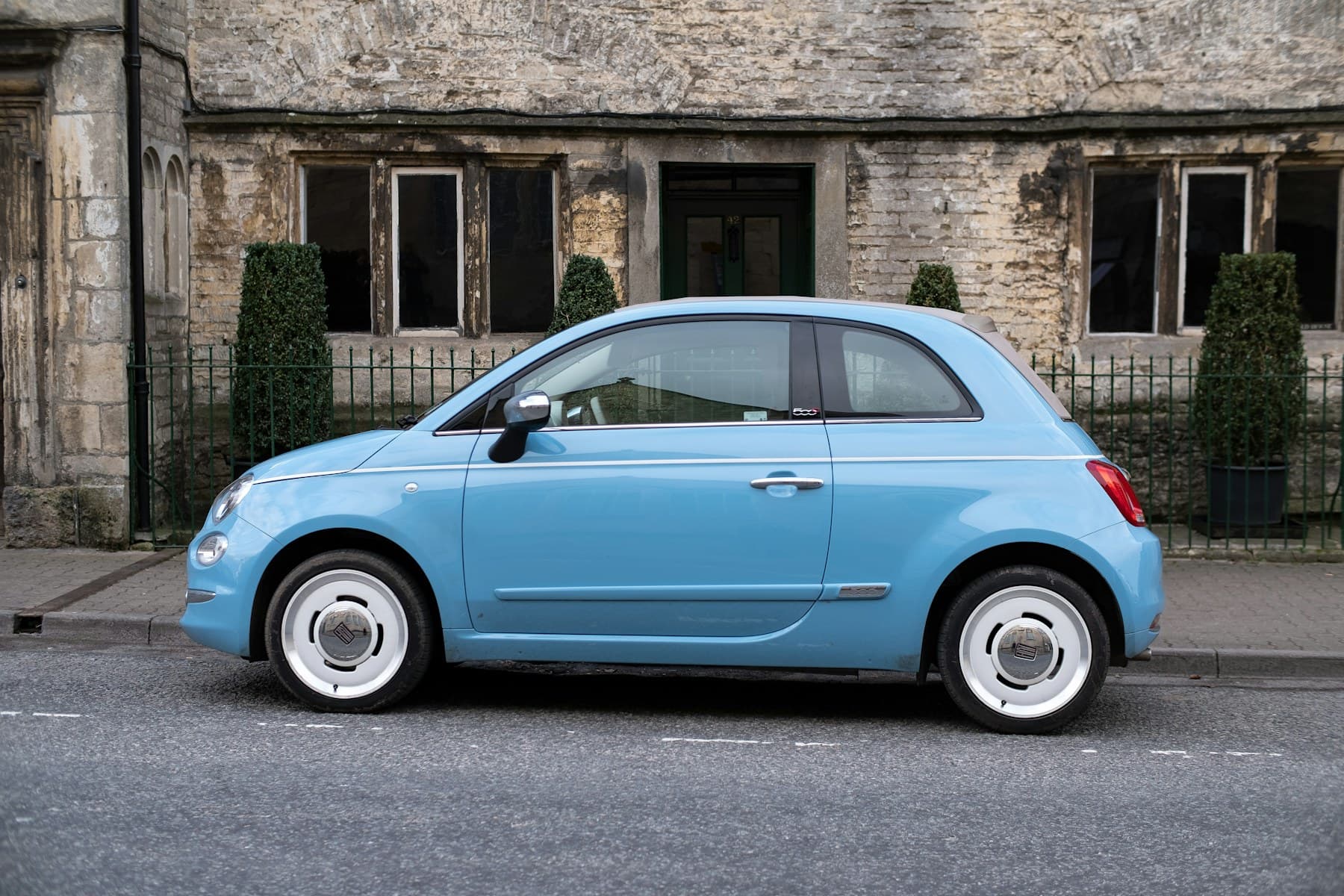 Blue compact car parked on a city street, shown as a private-ride demo image